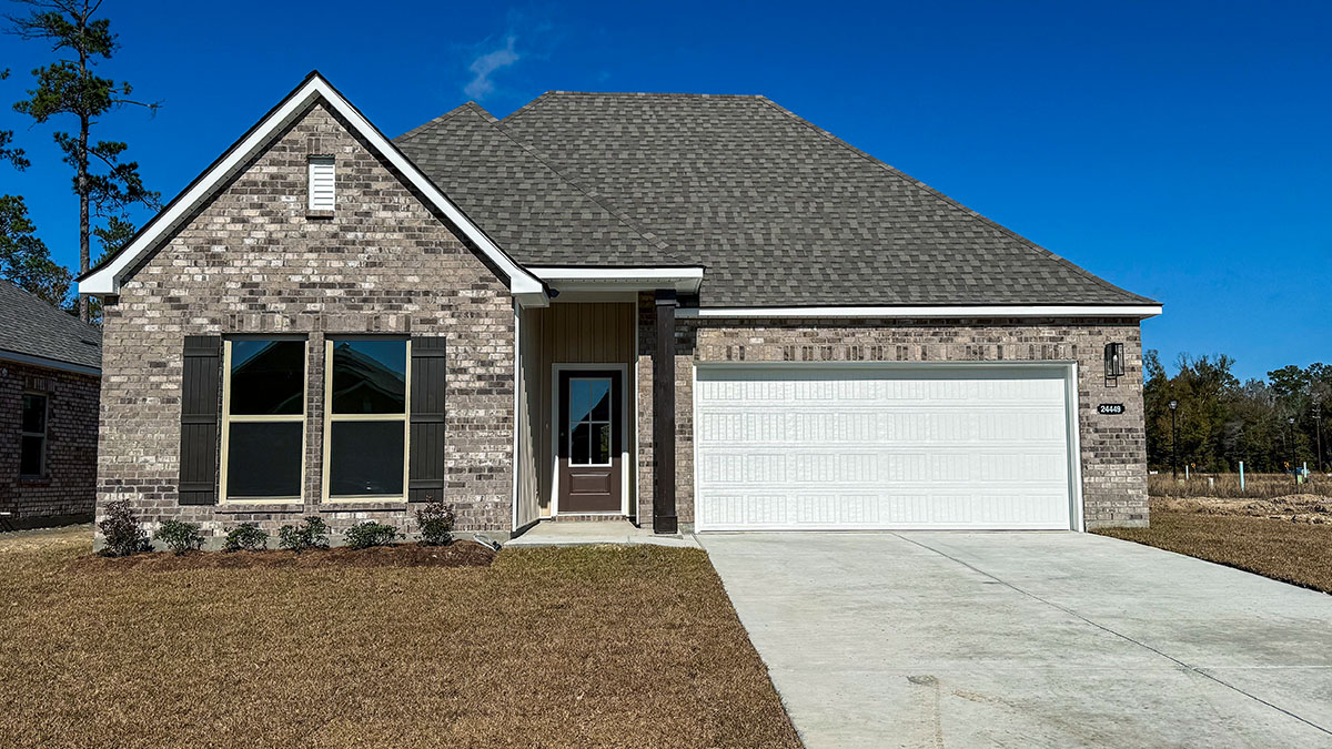 single-story home with grey brick and brown vinyl siding with brown front door and shutters with two-car garage
