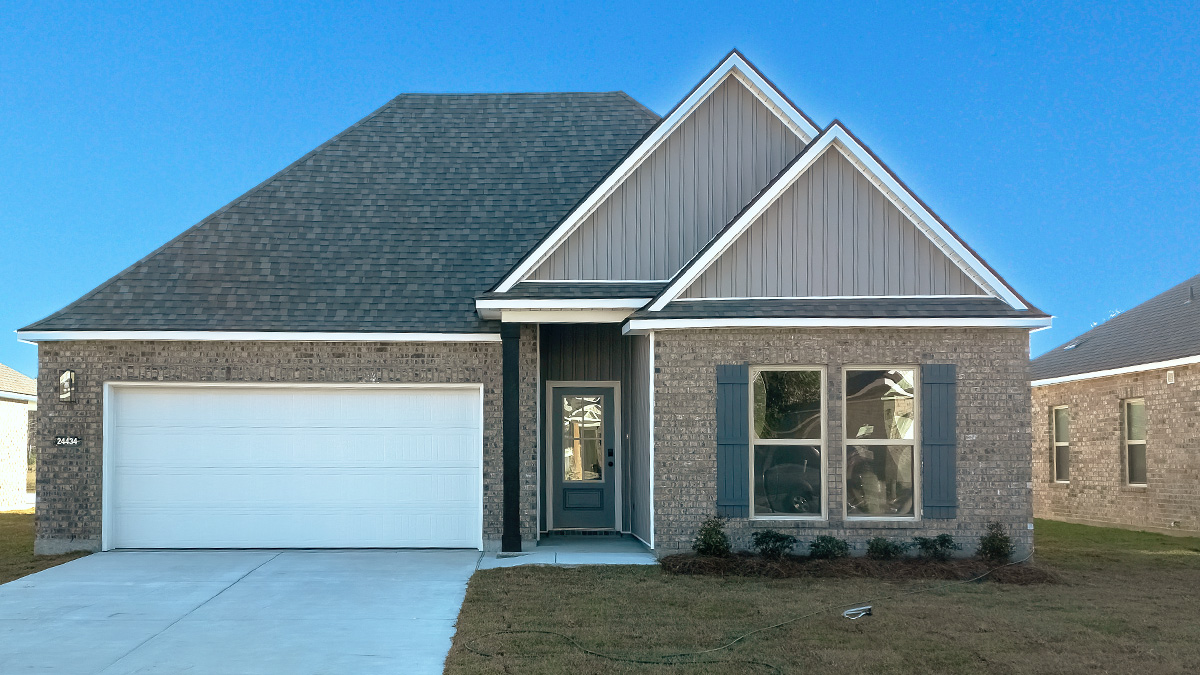single-story home with tan brick and grey vinyl siding with grey front door and shutters with two-car garage