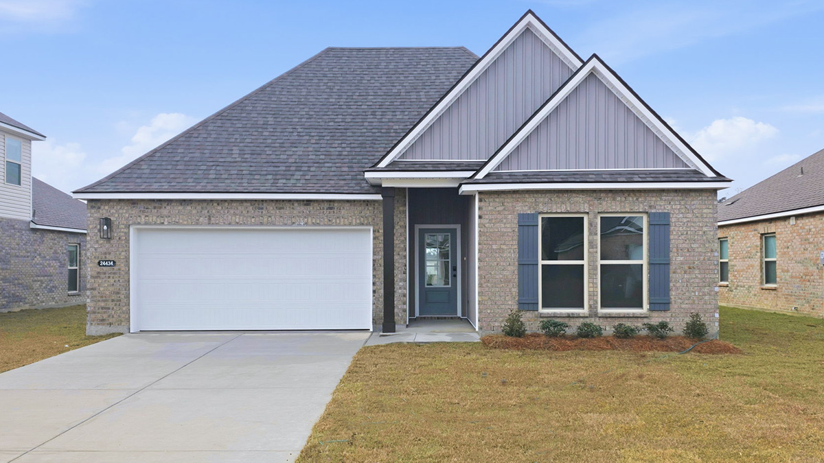 single-story home with tan brick and grey vinyl siding with grey front door and shutters with two-car garage