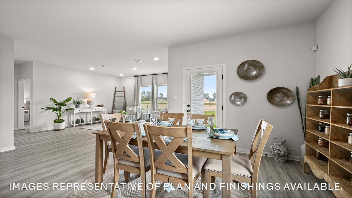 Living room with dual windows overlooking the backyard with the dining space nearby