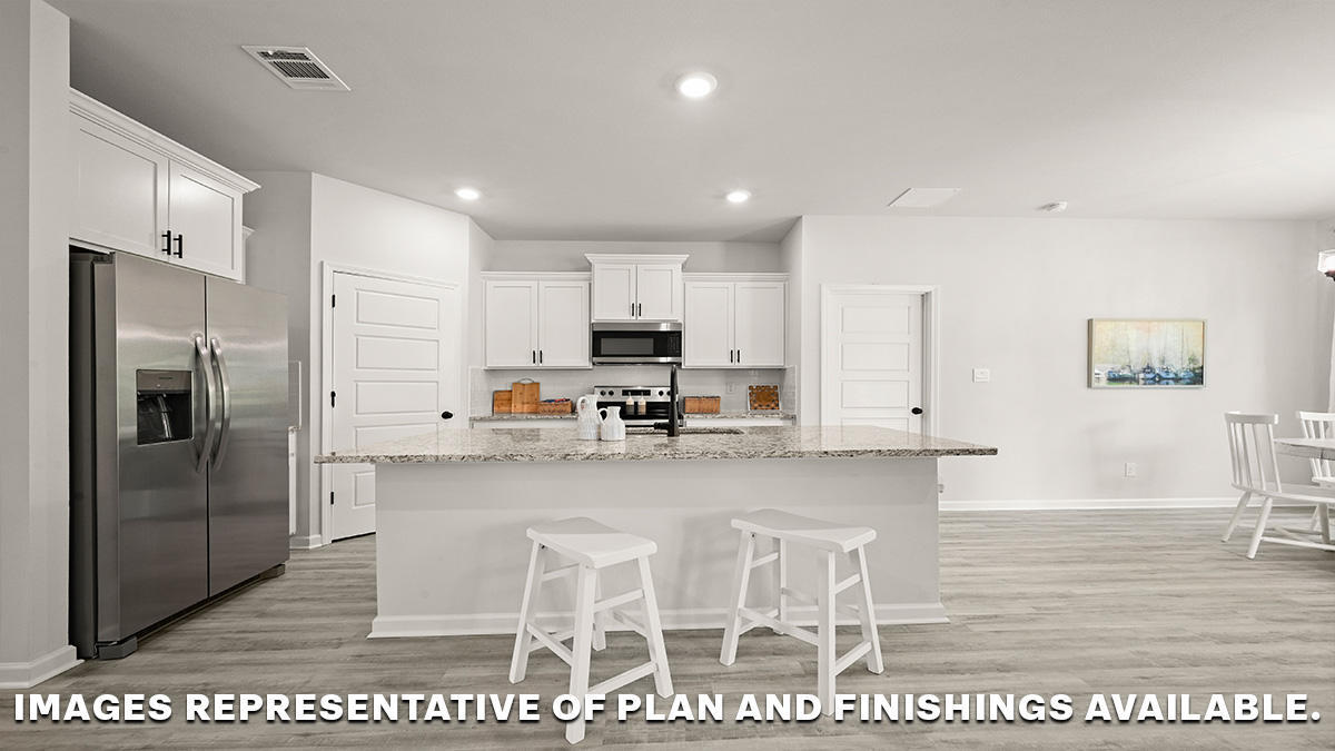 white kitchen island with stainless steel appliances and pantry with dining room to the right