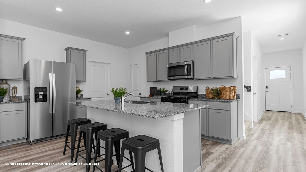 Gray kitchen island with stools with access to foyer