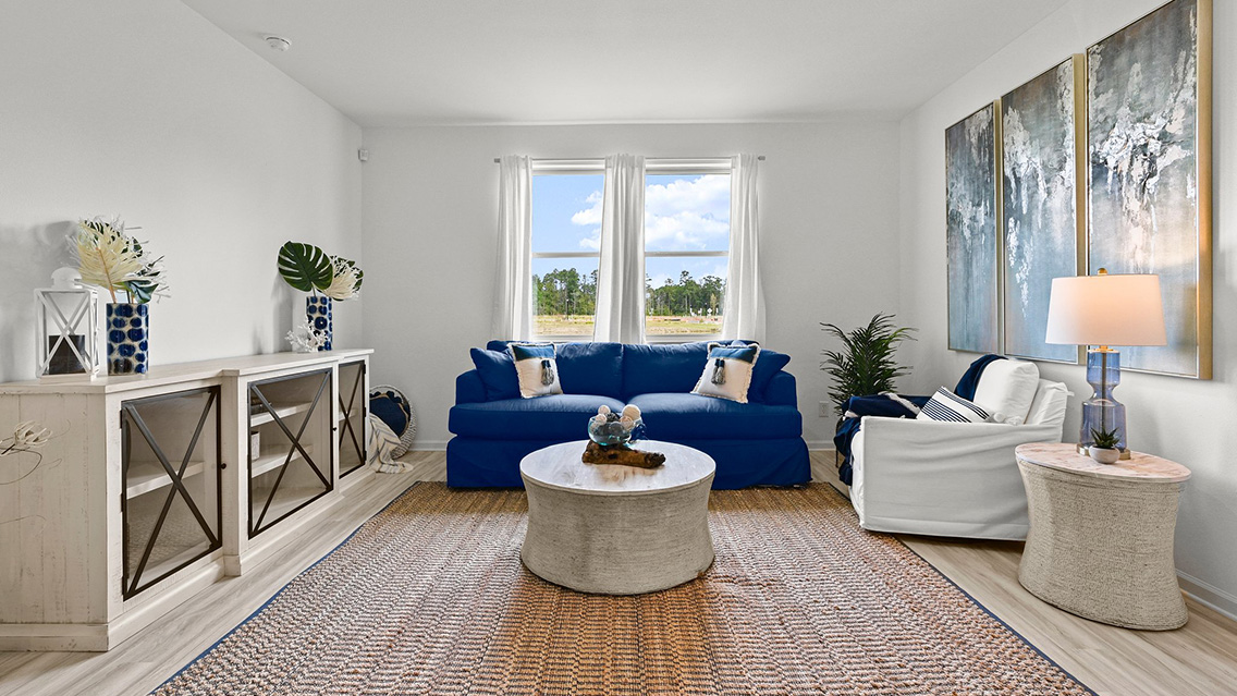 spacious living room with dual windows overlooking backyard