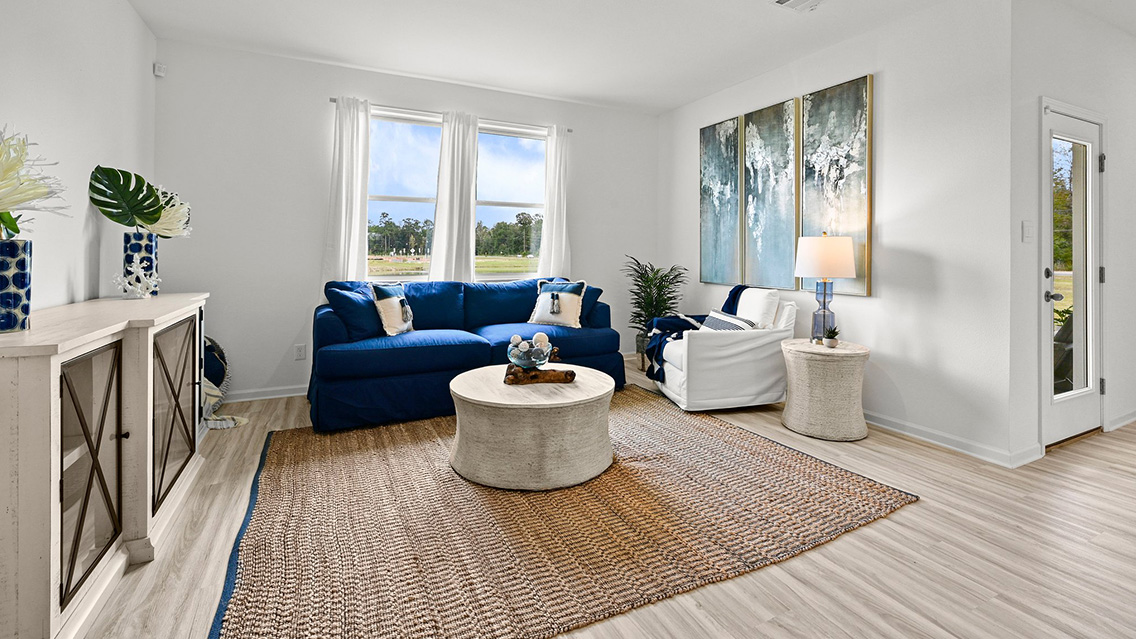 spacious living room with dual windows overlooking backyard
