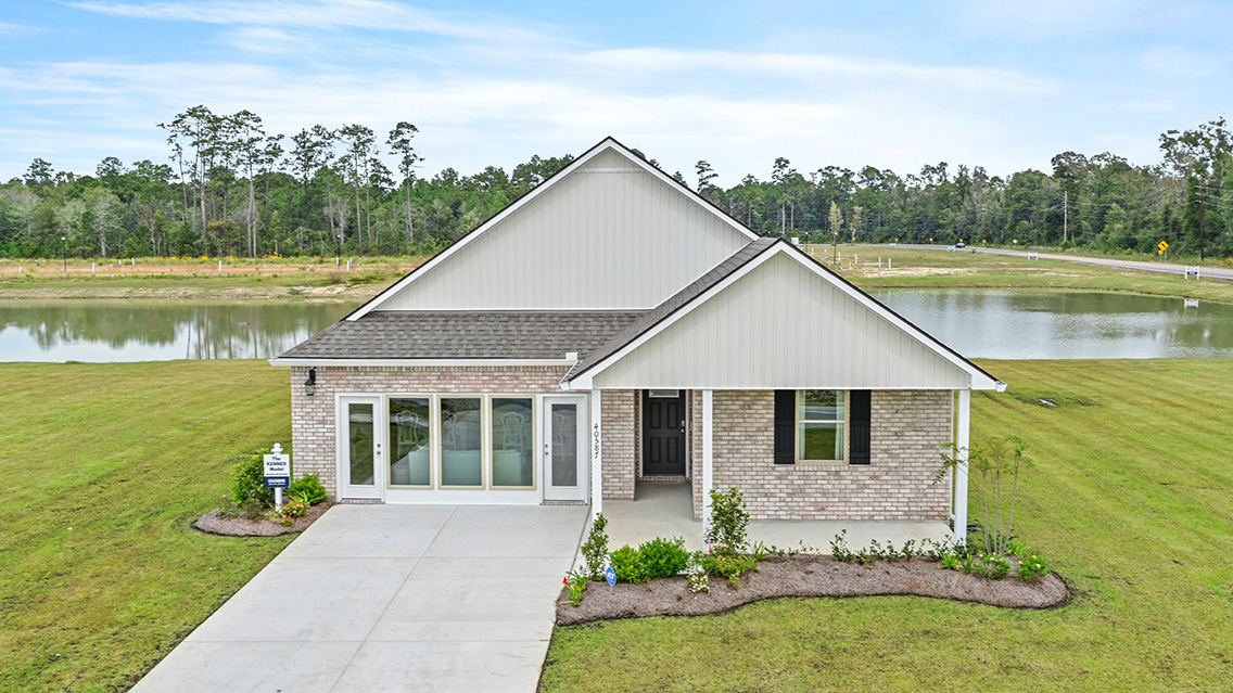 single-story home with tan brick and tan vinyl siding with large porch