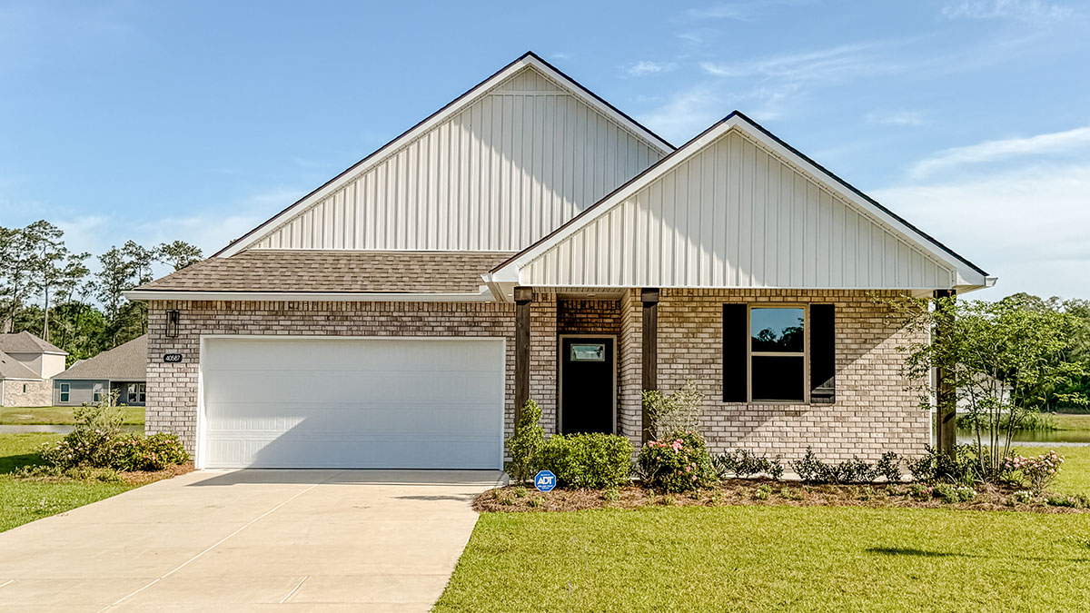 single-story home with tan brick and tan vinyl siding with large porch