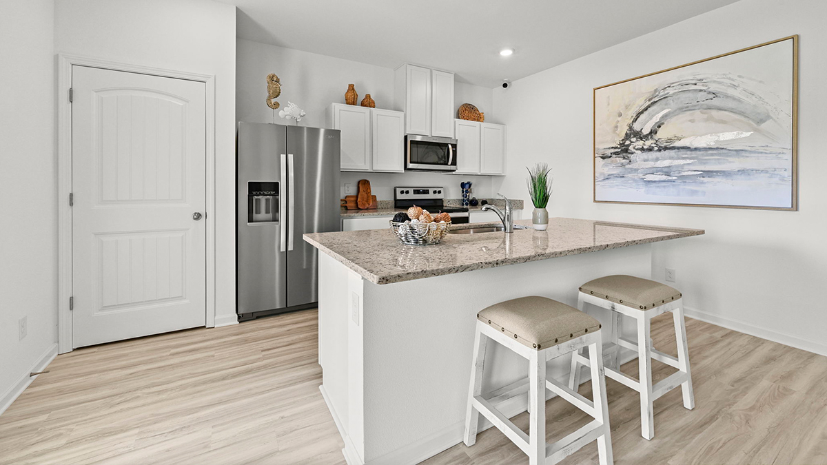 white kitchen island with stainless teel appliances
