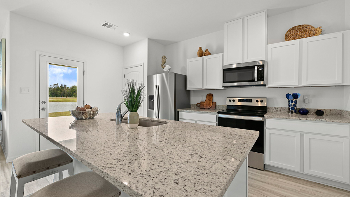 white kitchen island with stainless steel appliances