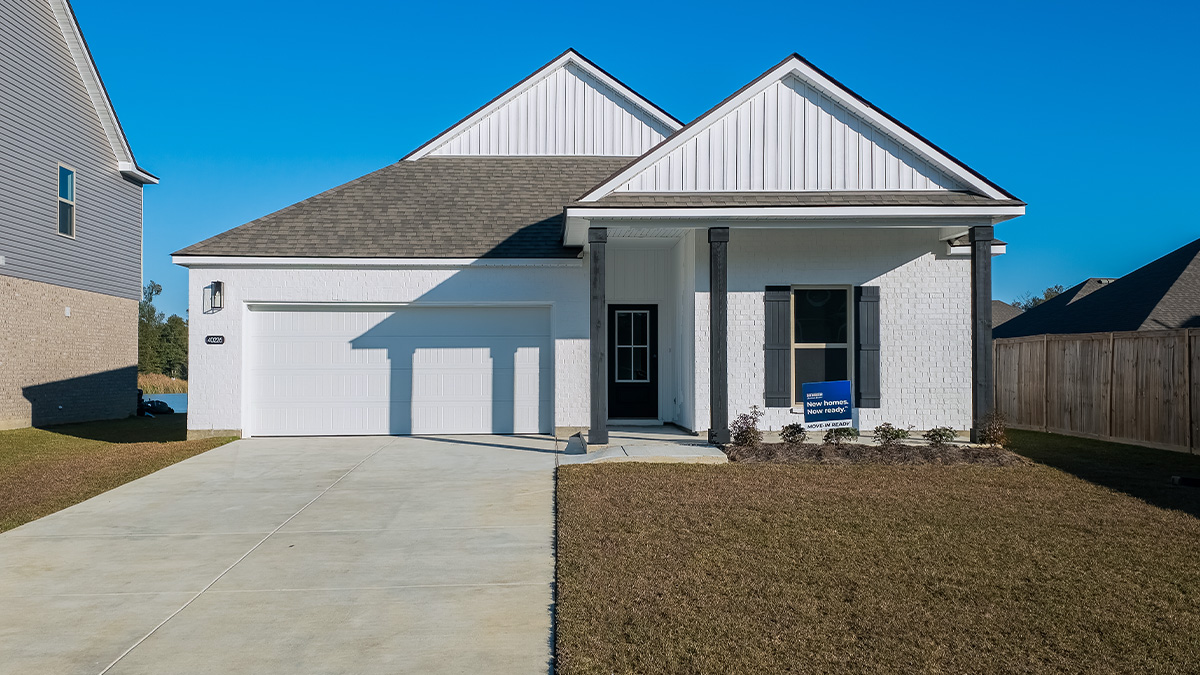 single-story home with white brick and black front door and shutters with porch and two-car garage