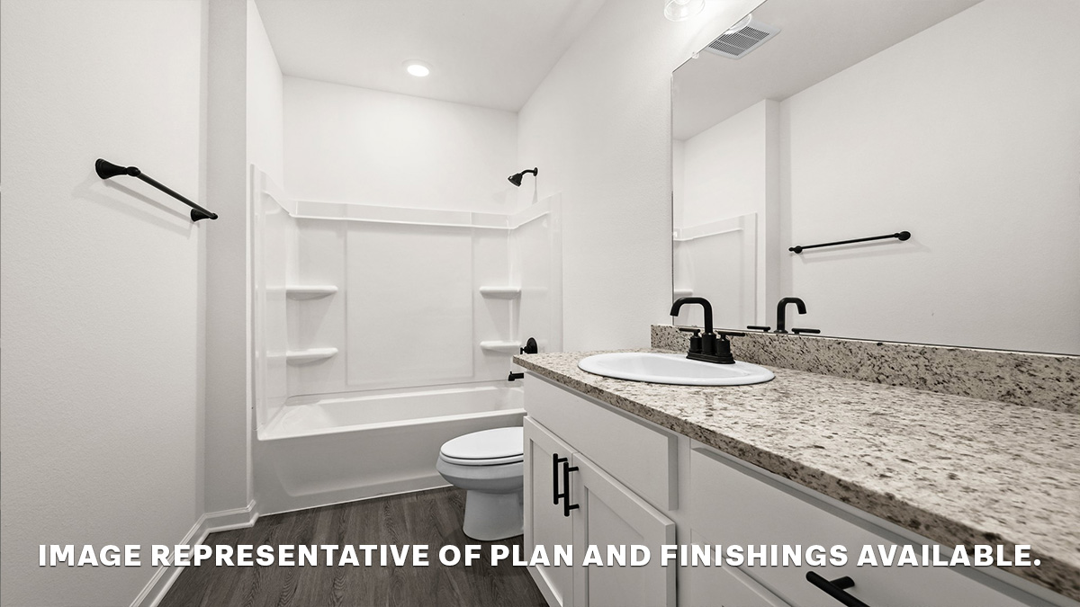 second bathroom with single vanity and shower tub combo and toilet