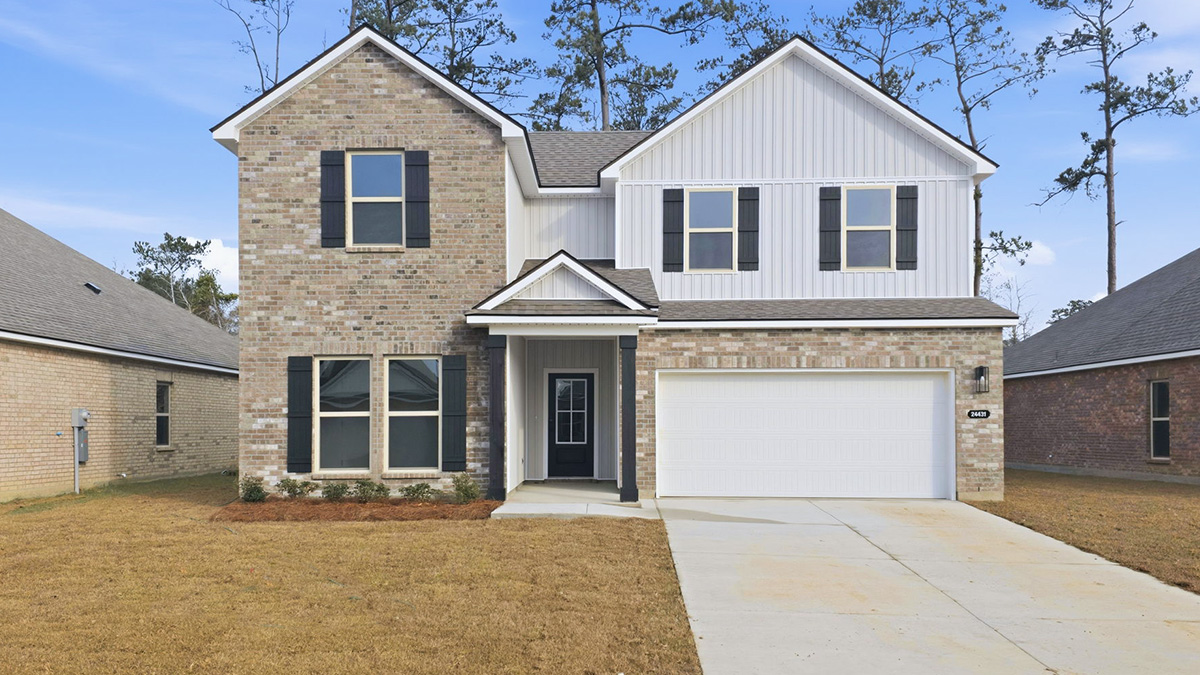 double-story home with tan brick and gray vinyl siding with black front door and shutters with porch and two-car garage