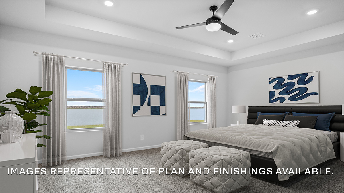 Large primary bedroom with dual windows overlooking the backyard