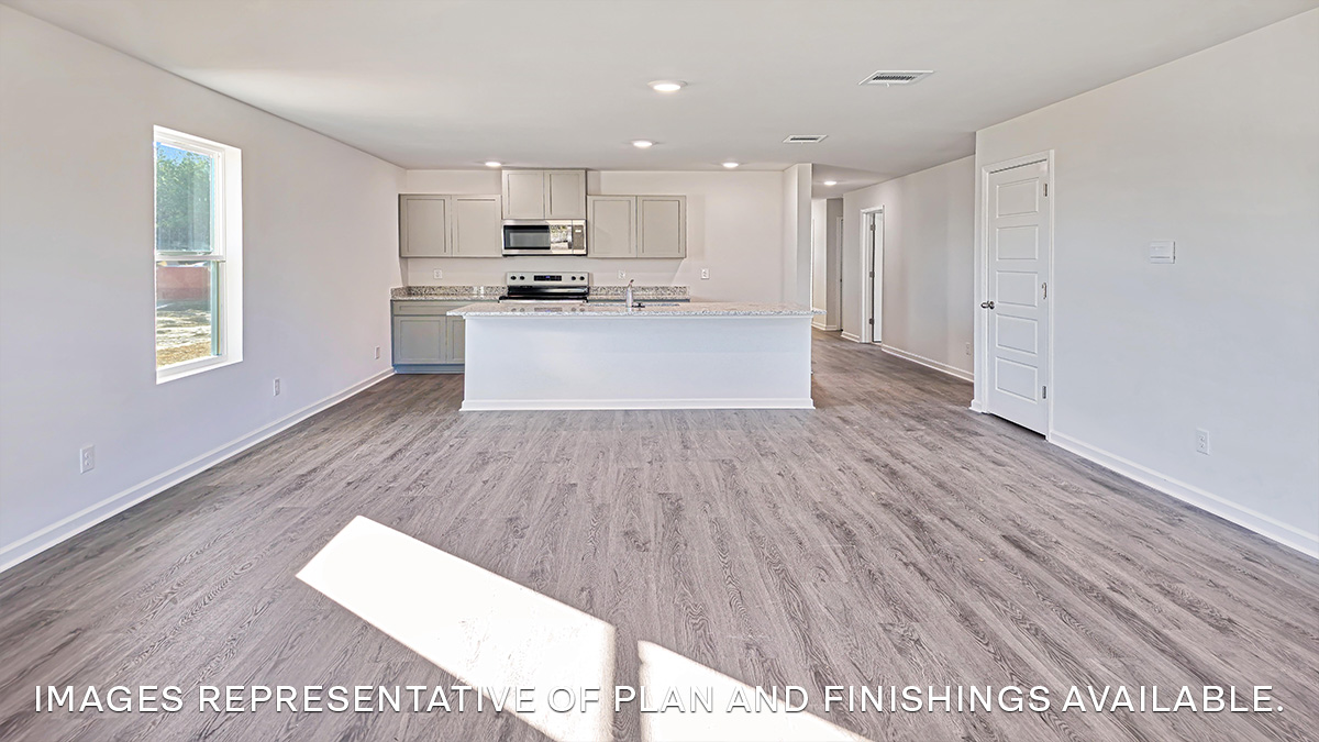 open concept living space with kitchen in the rear with gray kitchen island