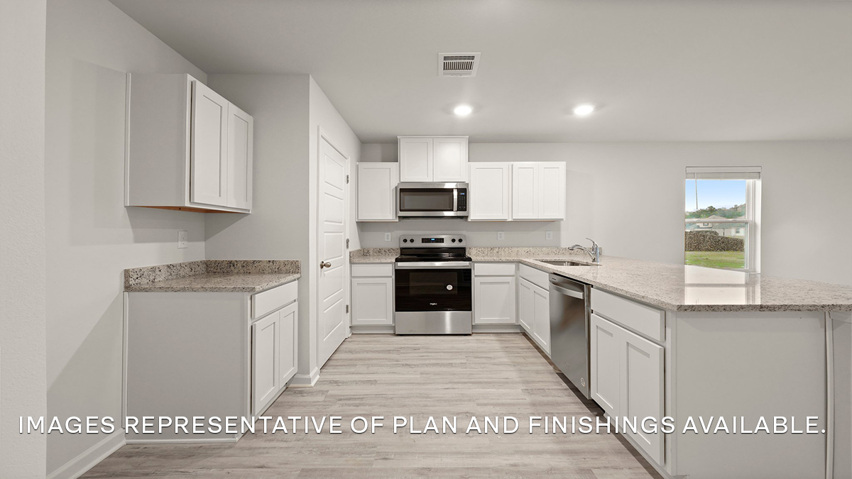 white kitchen peninsula with stainless steel appliances and pantry access