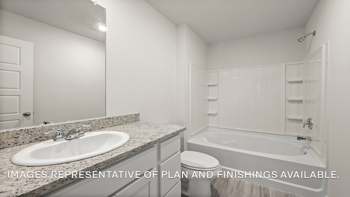 Primary bathroom single vanity, shower tub combo and toilet