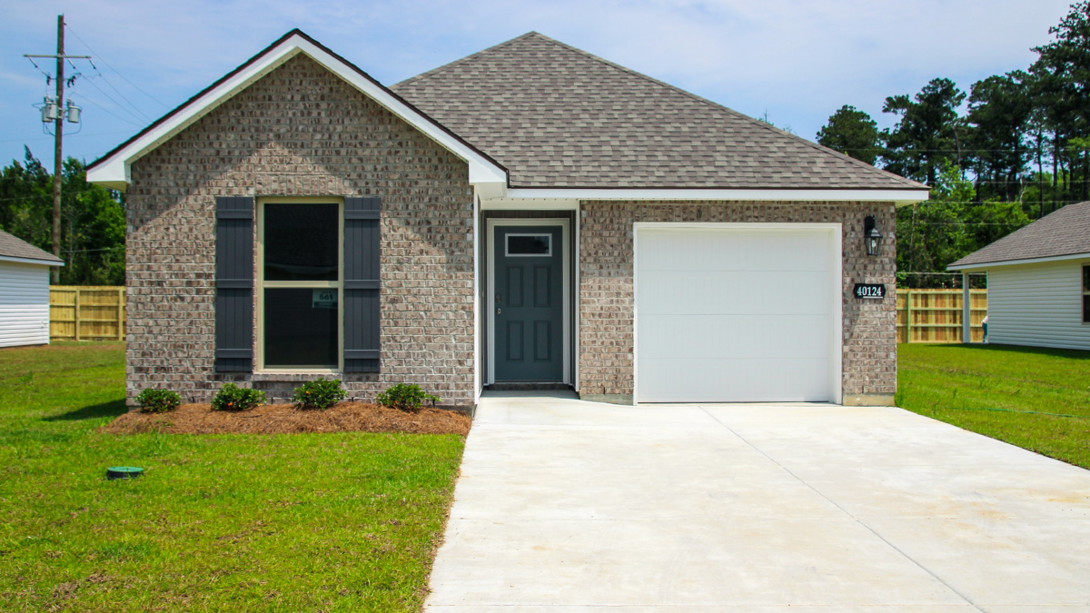 single-story home with brown brick and with gray front door and shutters with one-car garage
