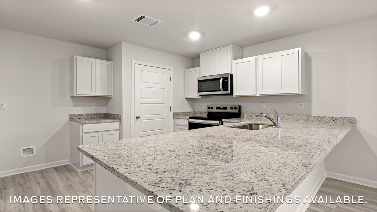 white kitchen island with stainless steel appliances and pantry access