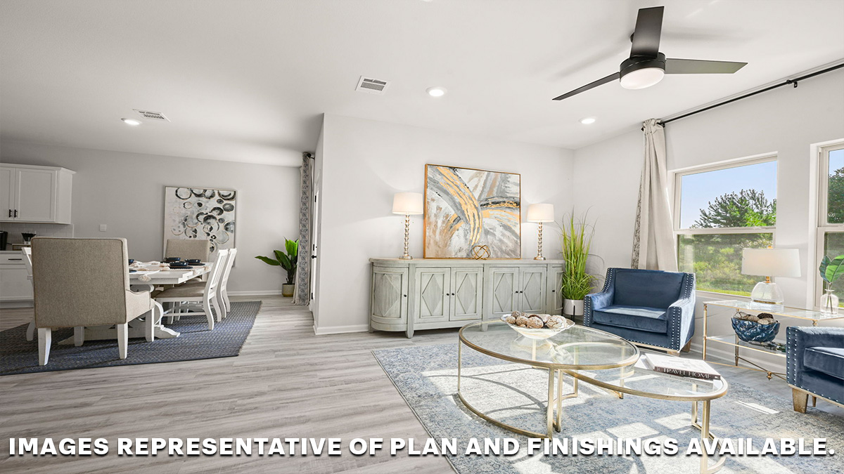 spacious living room with dual windows overlooking backyard