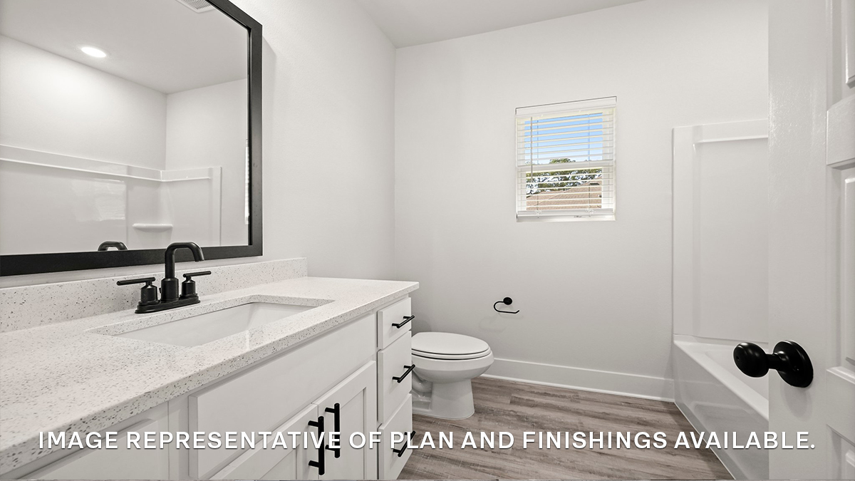 First guest bathroom with single vanity and toilet and shower tub combo