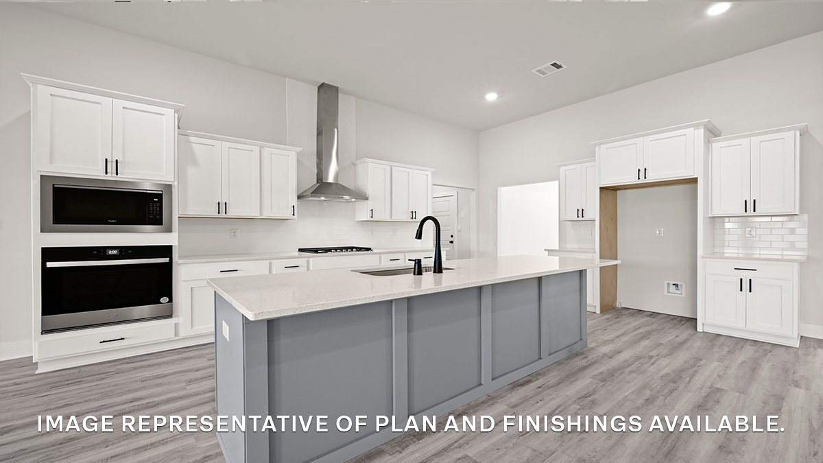 Gray kitchen island with stools and stainless steel gas appliances