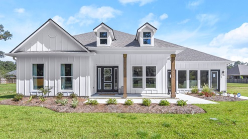single-story home with white hardie siding and black accents with cypress post porch