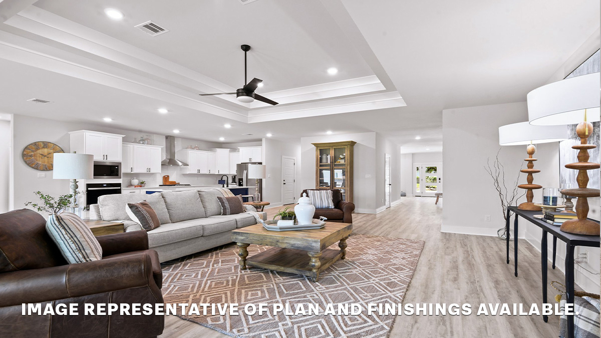 Open-concept living room with vaulted high ceilings and hallway to front of home