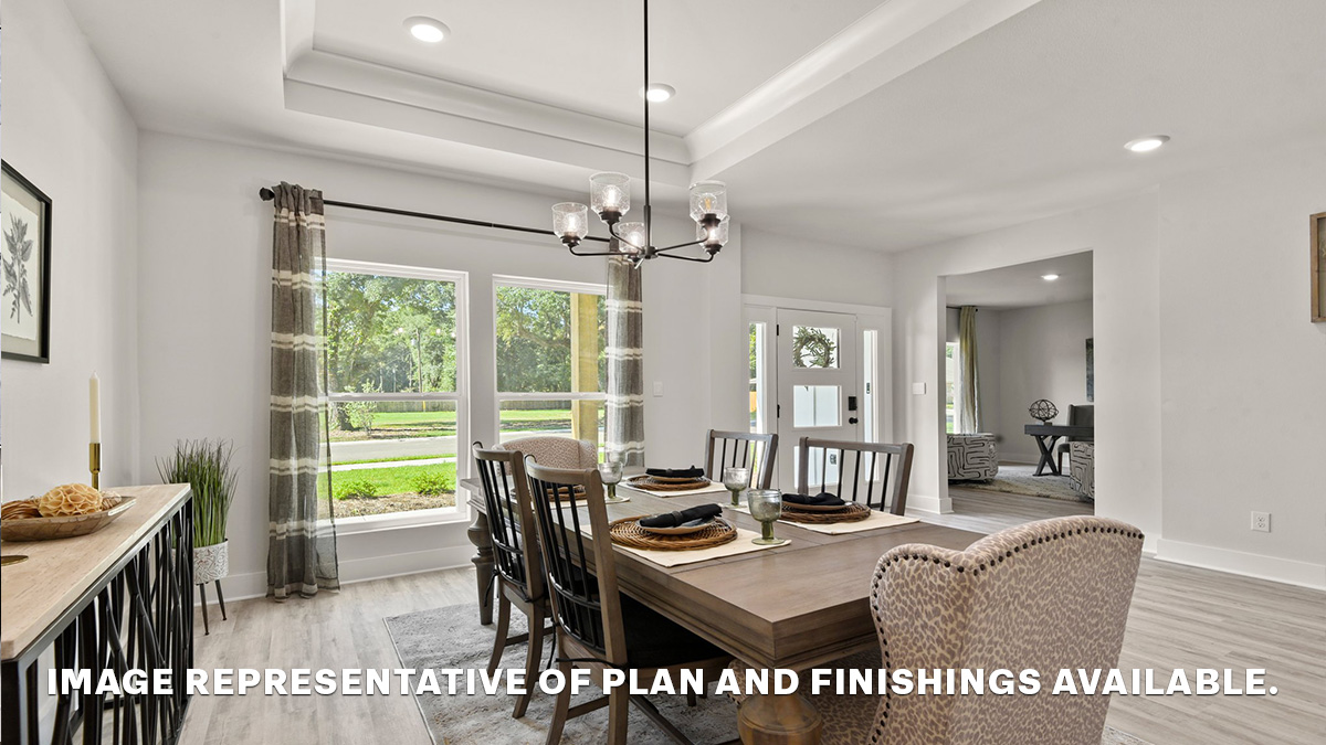 Open-concept dining room in the front area of the home with vaulted ceilings