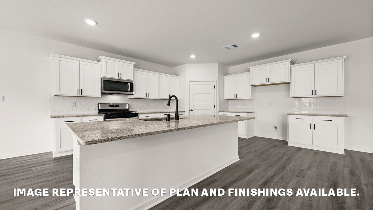 white kitchen island with gray granite and stainless steel appliances