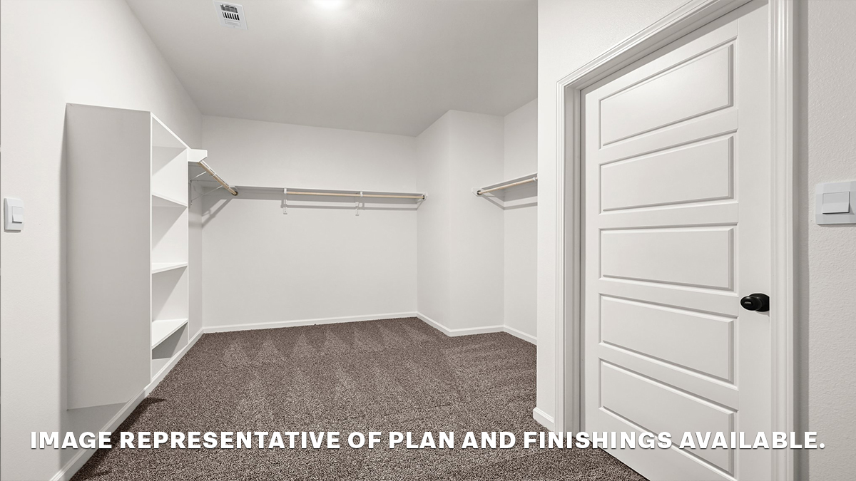 spacious walk in closet with dual shelving and racks with room for a shoe shelf