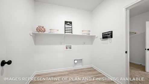 spacious laundry room with room for all your laundry needs and an ironing station