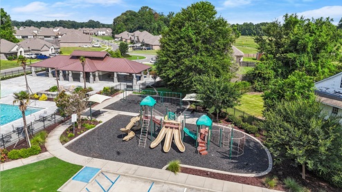 drone shot of playground next to pool