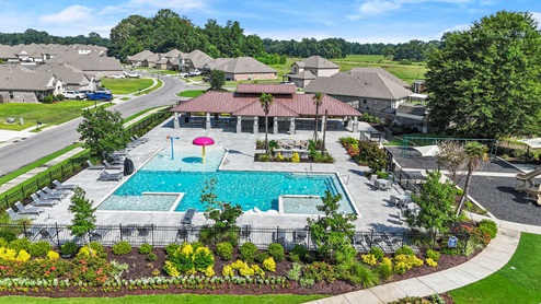 drone shot of pool next to playground
