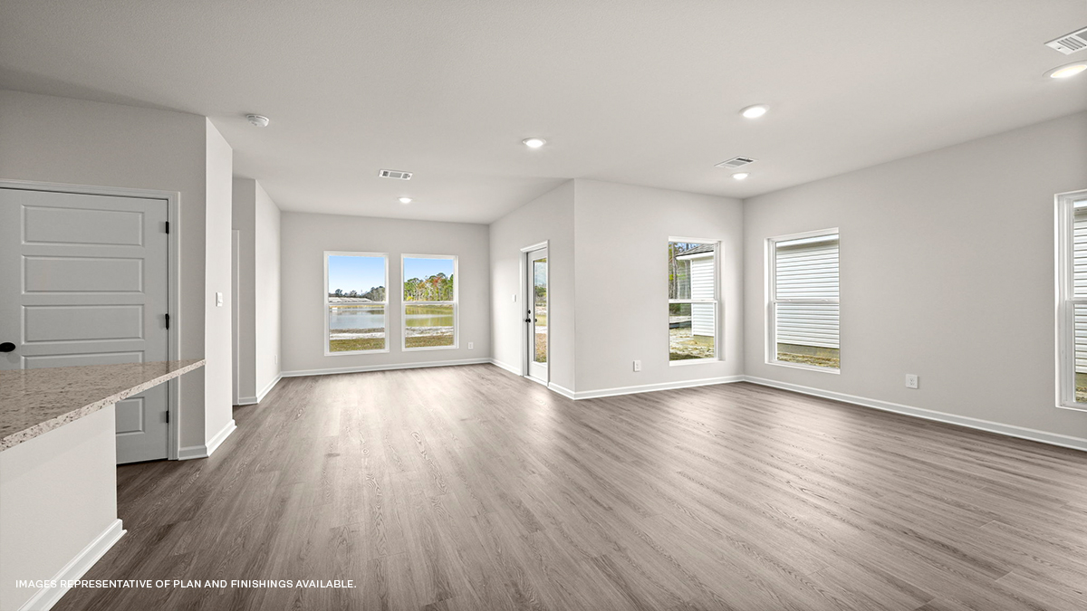 Open-concept living room with dining room and kitchen to the side