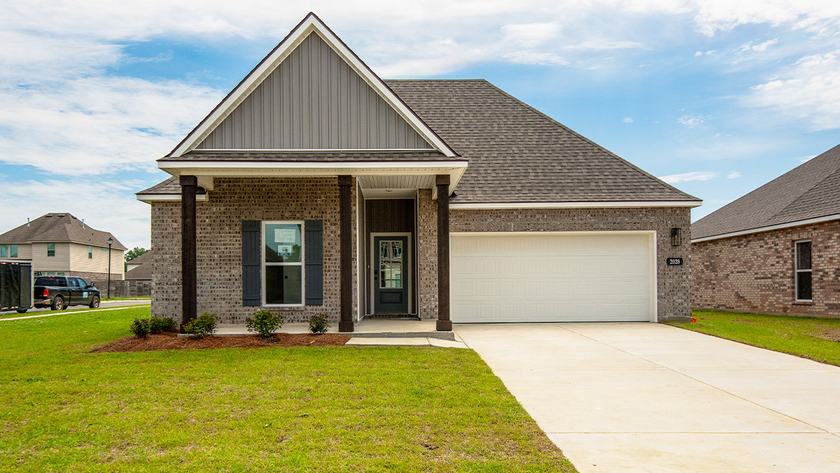 single-story home with brown brick and gray hardi siding with gray front door and shutters with two-car garage