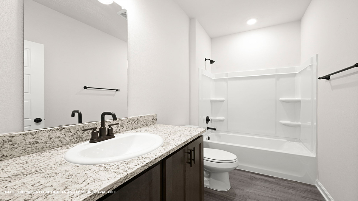 second bath with single vanity and toilet and shower tub combo