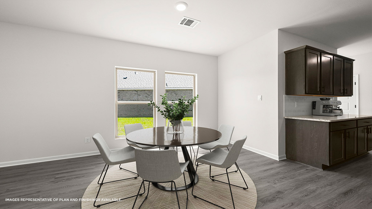 dining area near kitchen with dark cabinets on the side