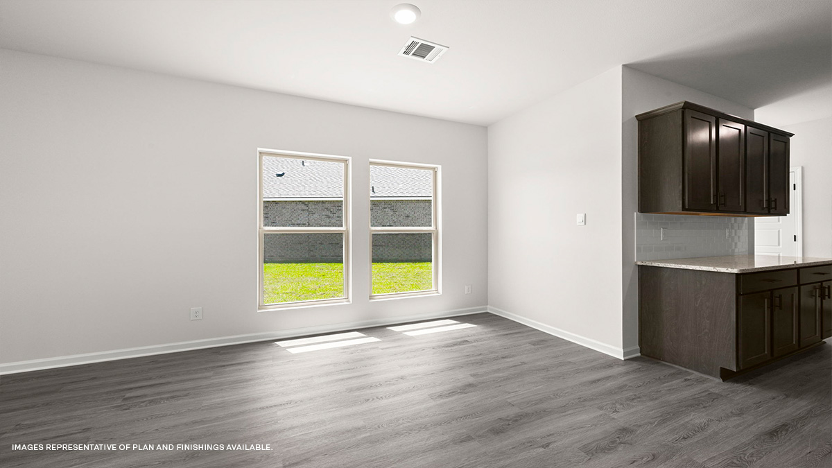 dining area near kitchen with dark cabinets on the side