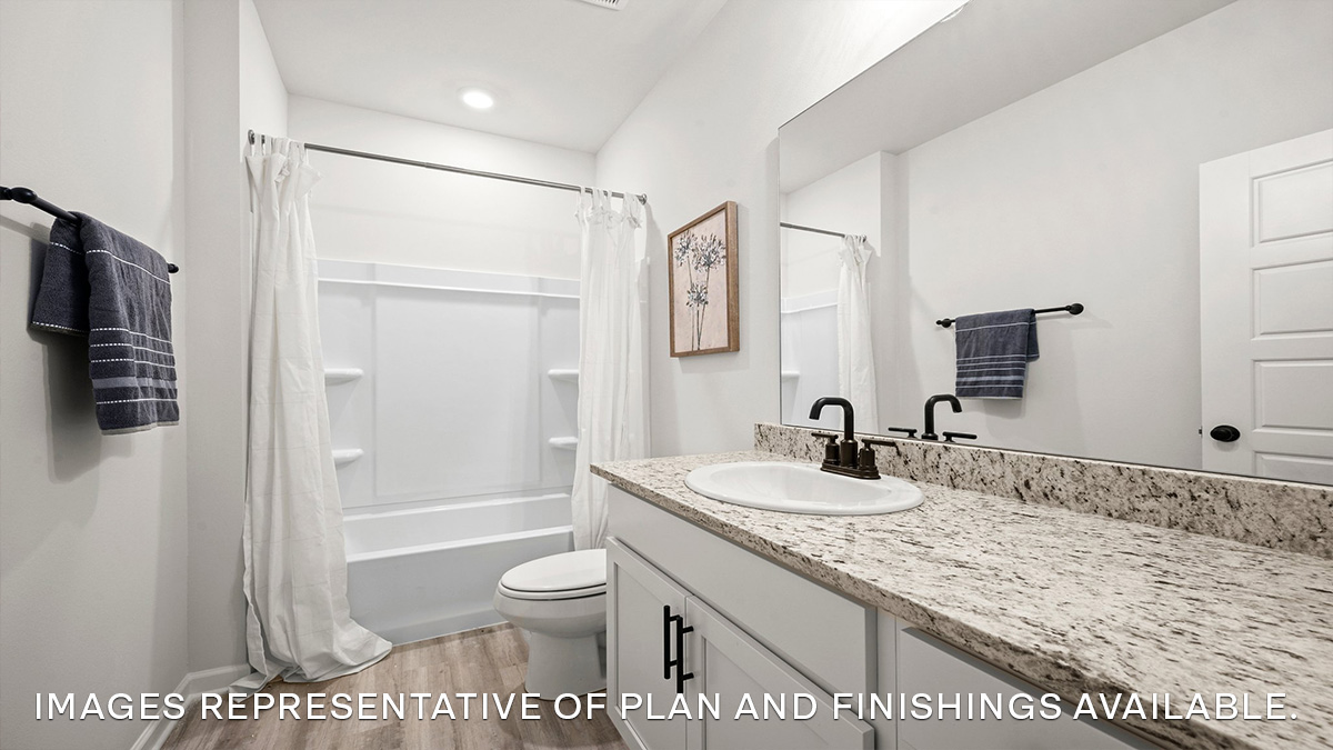 third bathroom with single vanity and shower tub combo and toilet