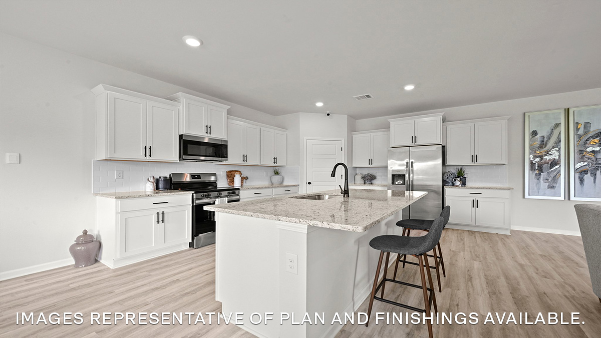 white kitchen island with white cabinets and stainless steel appliances and pantry access