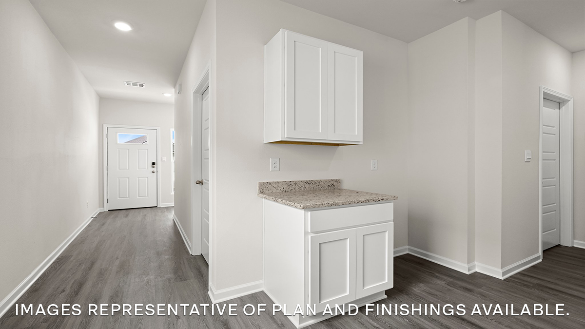 white kitchen cabinet with hallway leading to front door