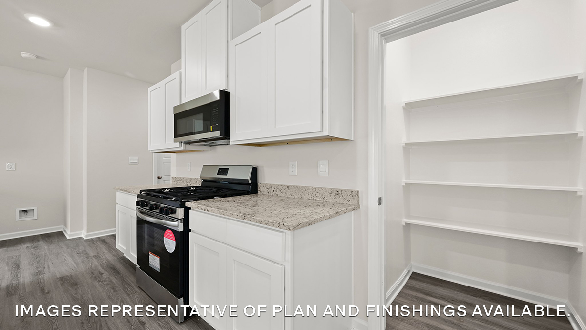 white kitchen island with stainless steel appliances and stools with access to pantry