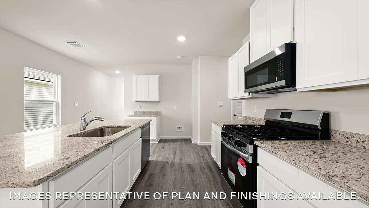 white kitchen island with stainless steel appliances and stools with access to pantry