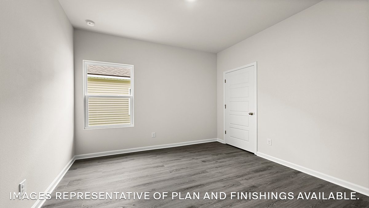 second bedroom with single window and room for a queen bed