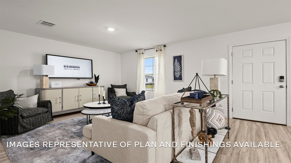 Open-concept living room with dual windows facing front of the home