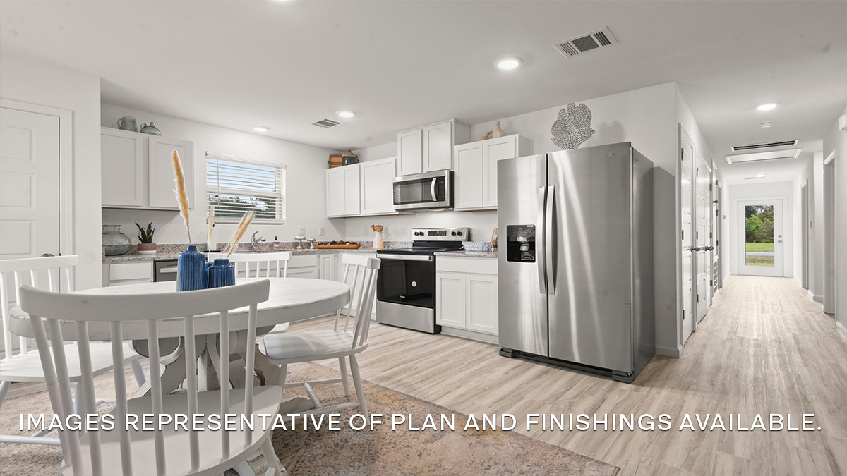 White kitchen cabinets with stainless steel appliances and eat in kitchen space
