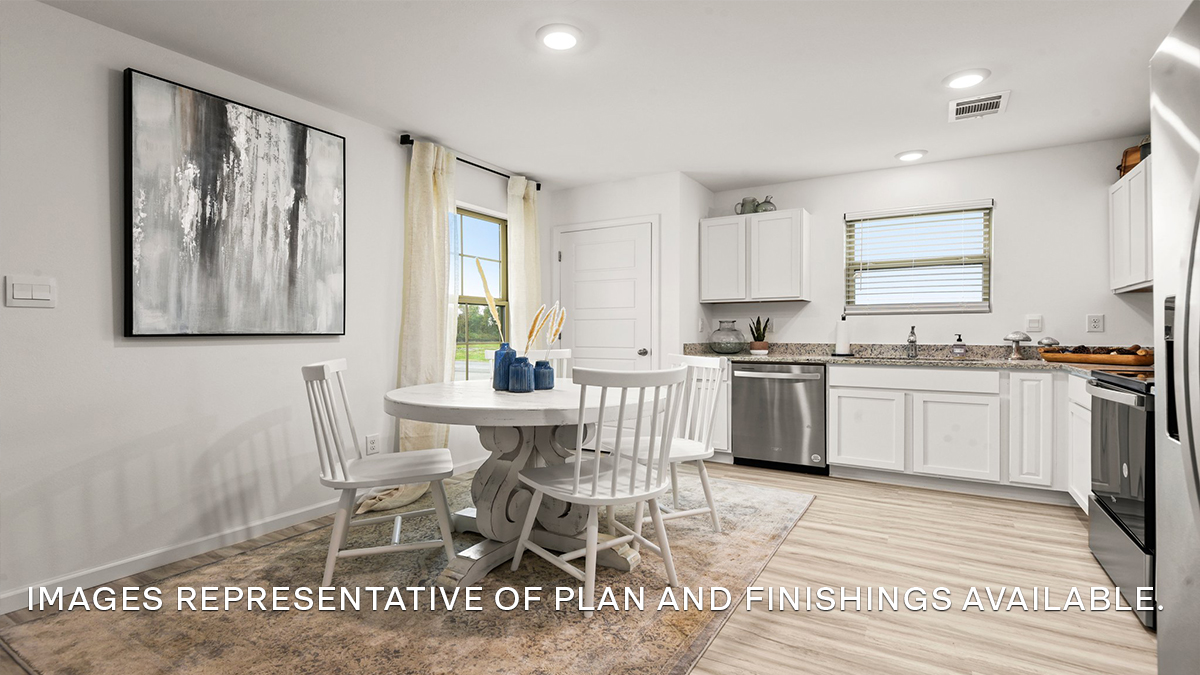 White kitchen cabinets with stainless steel appliances and eat in kitchen space