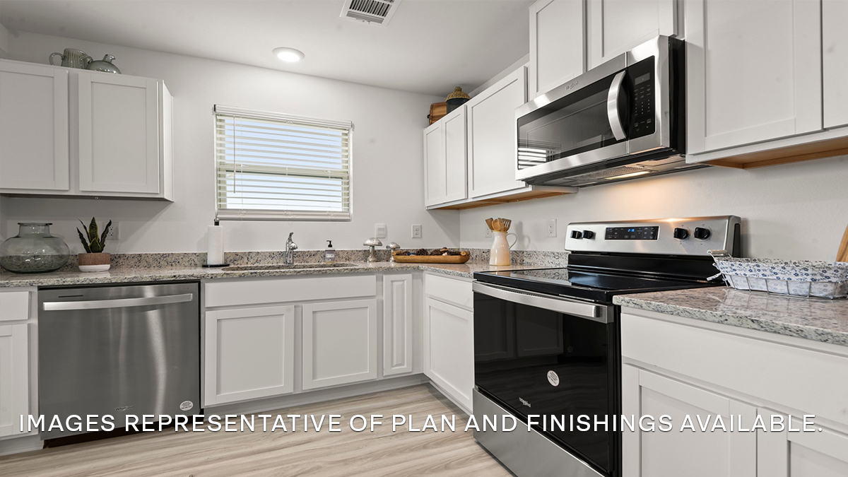 White kitchen cabinets with stainless steel appliances and eat in kitchen space