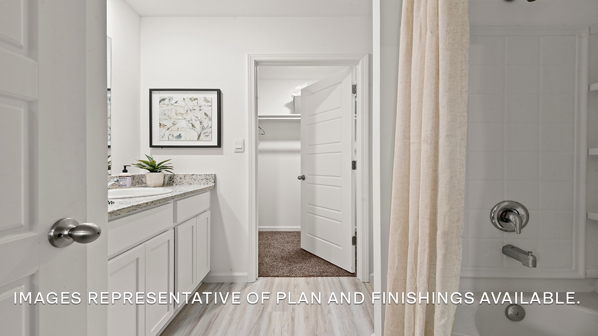 White dual vanities with shower and tub combo and toilet