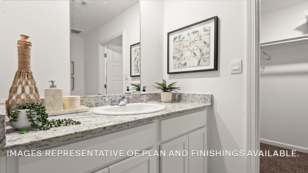 White dual vanities with walk-in closet access