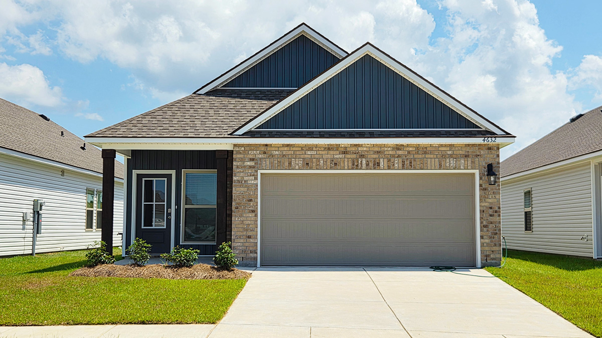 Single-story home with navy vinyl and brown brick. Black glass front door with black shutters and white trim.